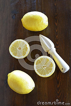 Concept with lemons and lemon squeezer