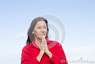 Concerned thoughtful woman praying hands