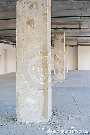 Concrete column in unfinished interior under construction