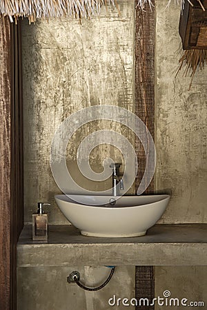 Concrete counter and hand washing sinks outside the toilet