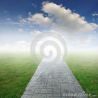 Concrete road in Grass fields and blue sky
