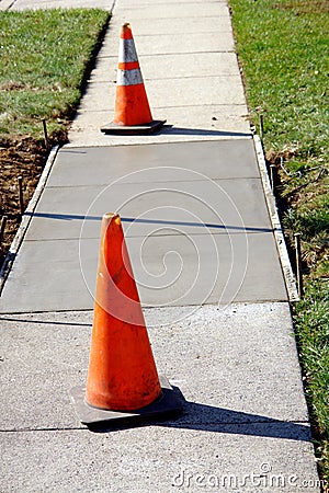 Concrete Sidewalk Repair on City Street with Cones