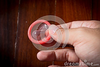 Condom in hand for using.