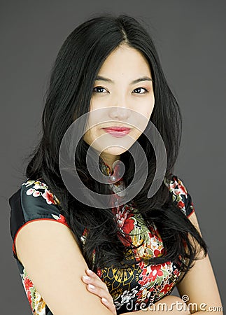 Confident Asian young woman with arms crossed