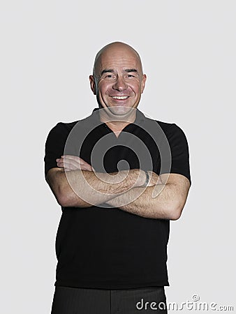 Confident Middle Aged Man With Arms Crossed