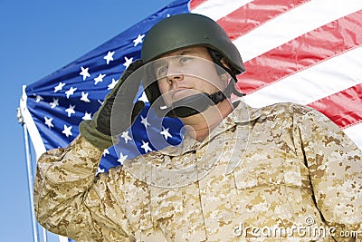 Confident Soldier Saluting In Front Of American Flag