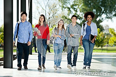 Confident Students Walking In A Row On Campus