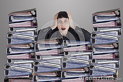 Confused business woman with files