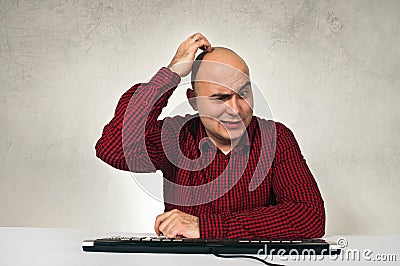 Confused man at office table