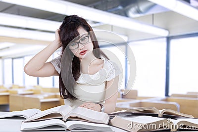 Confused student reading many books 3