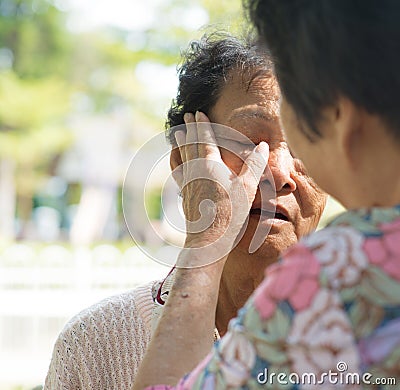 Consoling crying old mother