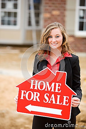 Construction: Agent Holding Home For Sale Sign