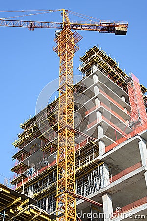 Construction site. Crane and High-rise Building Under Construction.