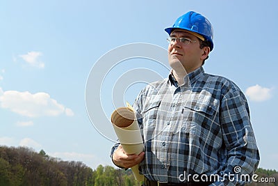 Construction site manager with building plans