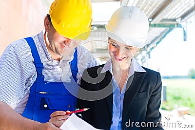 Construction Team with building plans on site