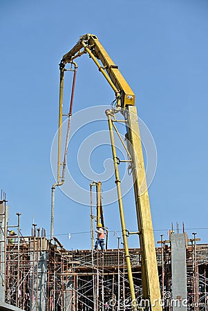 Construction workers with concrete pump crane