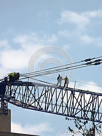 Construction workers on crane
