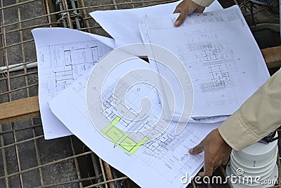 Construction workers referring to the construction drawing