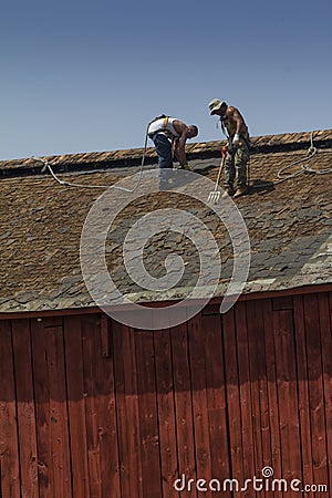 Construction Workers Roofing A Barn