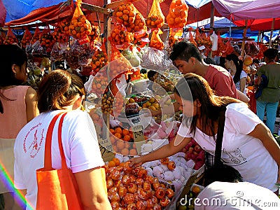 Consumers buy from a fruit vendor in a Market in Cainta, Rizal, Philippines, Asia