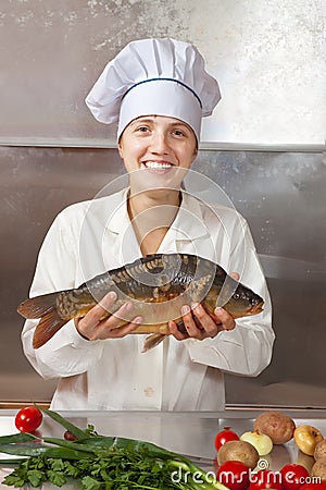 Cook woman with carp fish