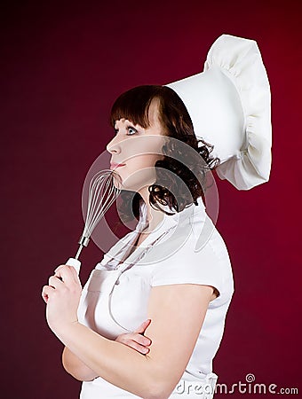 Cook woman holds a cooking spoon