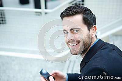 Cool guy smiling with mobile phone
