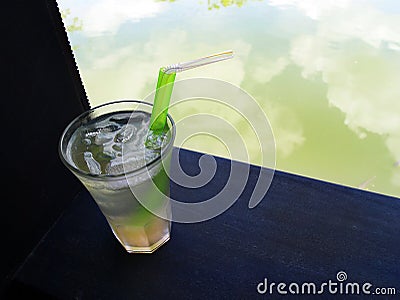 Cool iced lemongrass drink beside resort garden pool