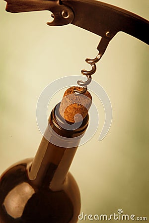 Corkscrew in stopper of bottle of wine