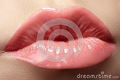 Cosmetics & lips. Macro of fashion lipgloss makeup in sweet kiss
