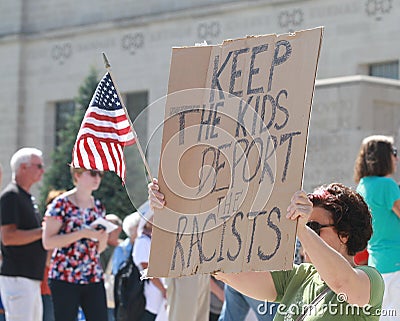 Counter Protestors with sign at a Rally to Secure Our Borders