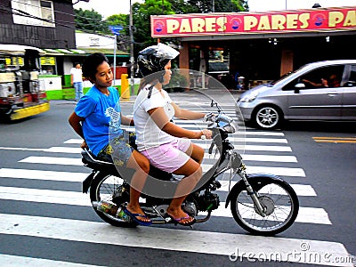 Couple of asian women riding a motorcycle