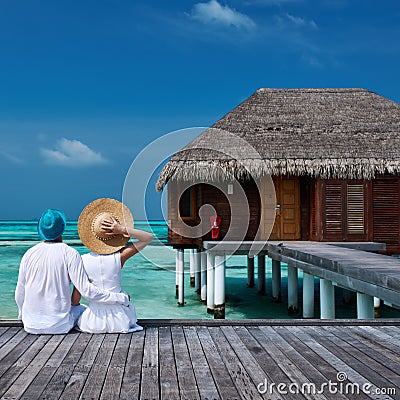 Couple on a beach jetty at Maldives