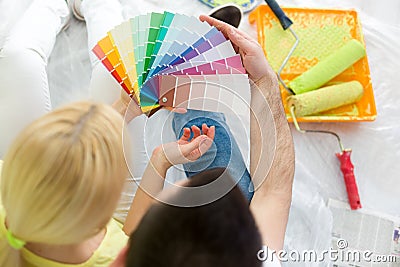 Couple choosing colors to paint new house