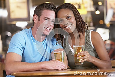 Couple Drinking Beer In A Pub