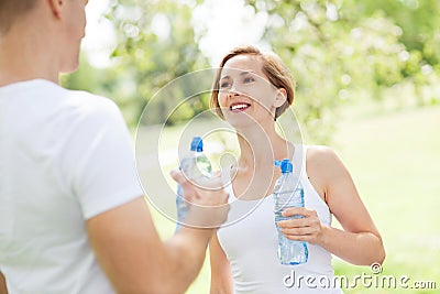 Couple drinking water after exercise