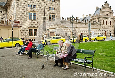 Couple of elderly tourists sit on the bench