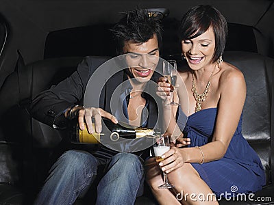 Couple Enjoying Champagne In Limousine