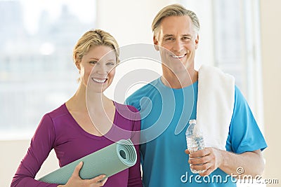 Couple With Exercise Mat; Water Bottle And Towel In Club