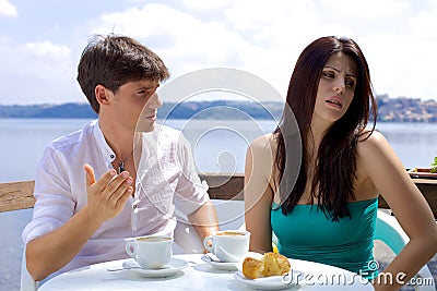 Couple fighting in vacation during breakfast on lake