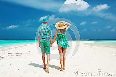 Couple in green on a beach at Maldives