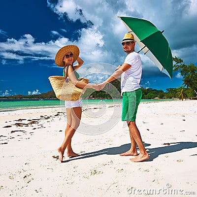 Couple in green on a beach at Seychelles