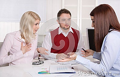 Couple has consultation with consultant at desk.
