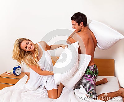 Couple has fun in bed. Laughter, joy and eroticism
