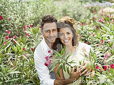 Couple have fun choosing flower pots in a greenhouse