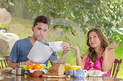 http://thumbs.dreamstime.com/x/couple-having-breakfast-fighting-over-bills-home-garden-background-32562917.jpg