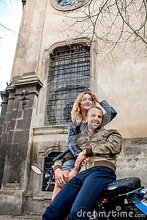 Couple having fun on the motorcycle in the old city