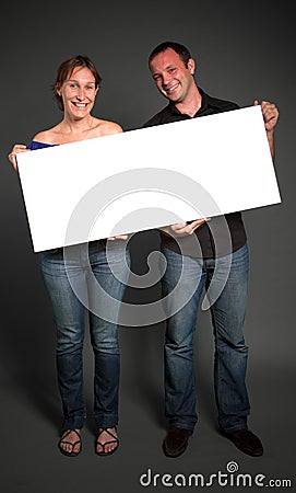 Couple holding a blank sign