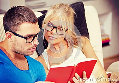 Couple at home with book