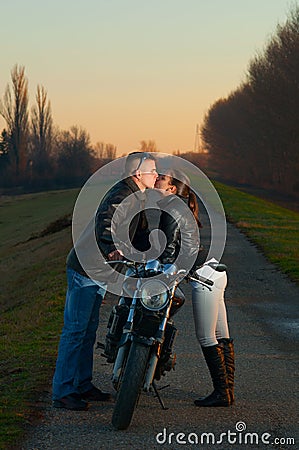 Couple kissing over the motorcycle